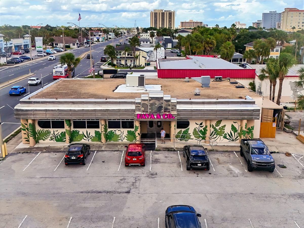 Aerial view of the Kava and Company building in Jacksonville Beach with its private parking lot